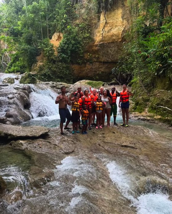 A guide leading swimmers through the Blue Hole pools inland from Ocho Rios
