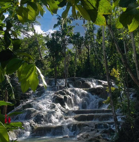 Climbers picking their footholds on the wet terraces of the falls